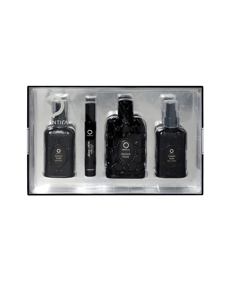 Set de regalo Orientica Amber Noir que incluye Eau de Parfum 80 ml, Fragrance Mist 115 ml, Miniatura 10 ml y Loción Corporal 115 ml en caja negra y plateada.